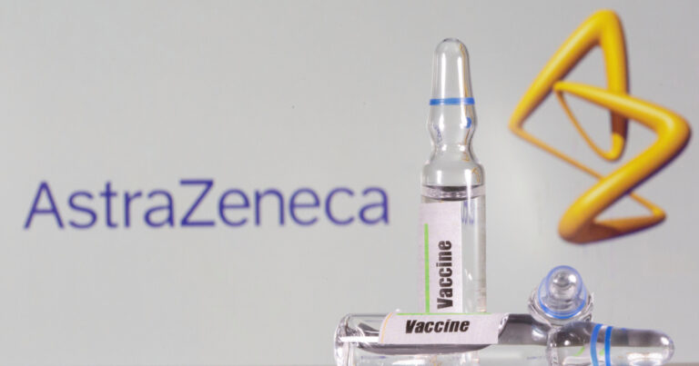FILE PHOTO: A test tube labelled with the vaccine is seen in front of AstraZeneca logo in this illustration taken